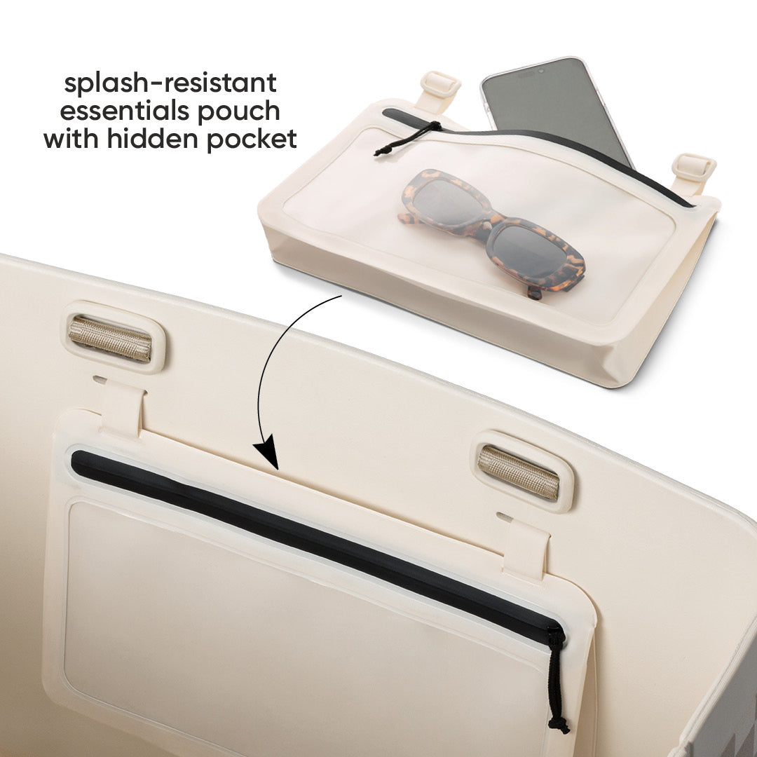 Owala Sun-Day Collapsible Tote in Checkin' In showing the splash-resistant essentials pouch detached above with a phone and tortoiseshell sunglasses inside, and an arrow pointing to where it attaches on the cream tote, with text overlay reading "splash-resistant essentials pouch with hidden pocket"