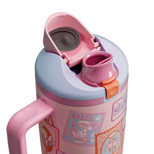 Owala FreeSip Tumbler in Sending Love, pink flip cap open exposing pink FreeSip spout with orange accent over patterned body and pink side handle